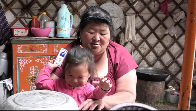 Mum and baby play with mobile phone